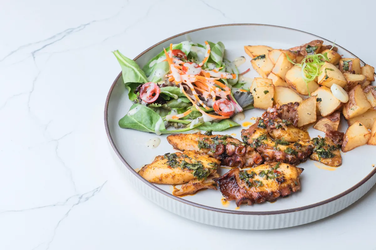 Charcoal-grilled pulpo (octopus) with potatoes and salad at Fusionista, Montclair NJ